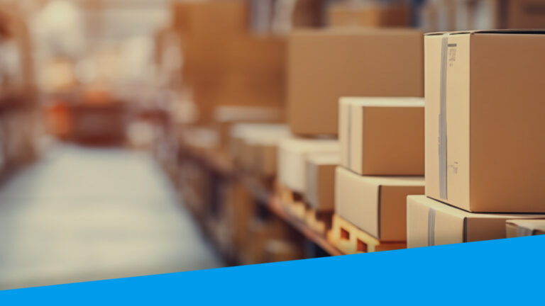 An image showing a warehouse aisle. Boxes are stacked in the foreground.