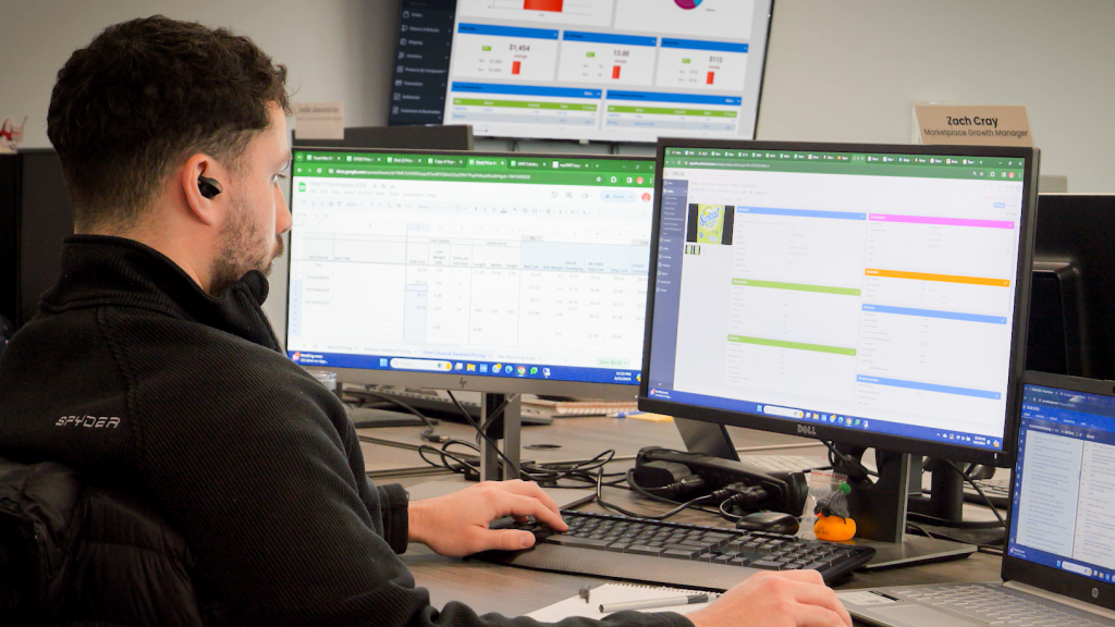 An image showing someone looking at a Sellercloud dashboard on their computer.