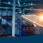 An image depicting a warehouse worker using a tablet in a warehouse.
