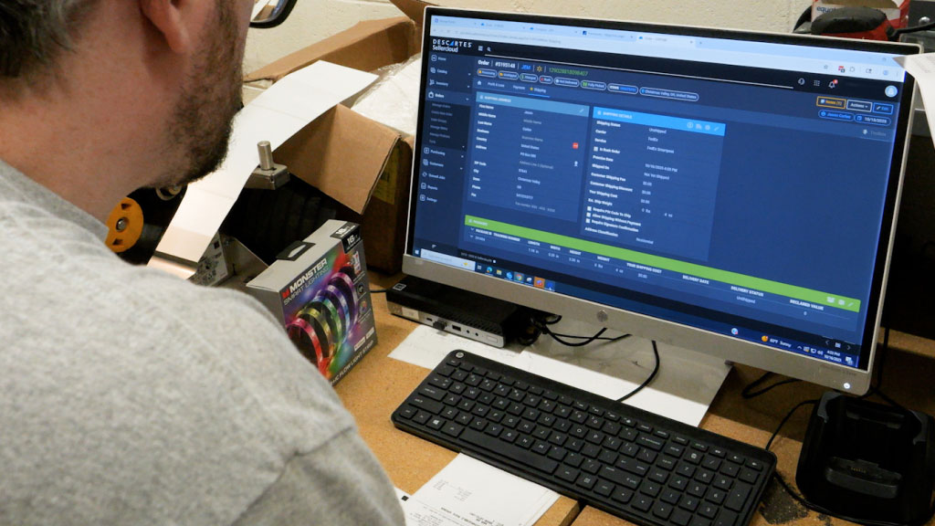 An image showing someone using Sellercloud to manage and order.