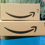 An image showing someone holding two packages, both featuring the Amazon smile logo.