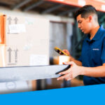 An image showing a warehouse worker scanning an order item.