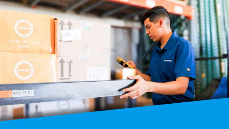 An image showing a warehouse worker scanning an order item.
