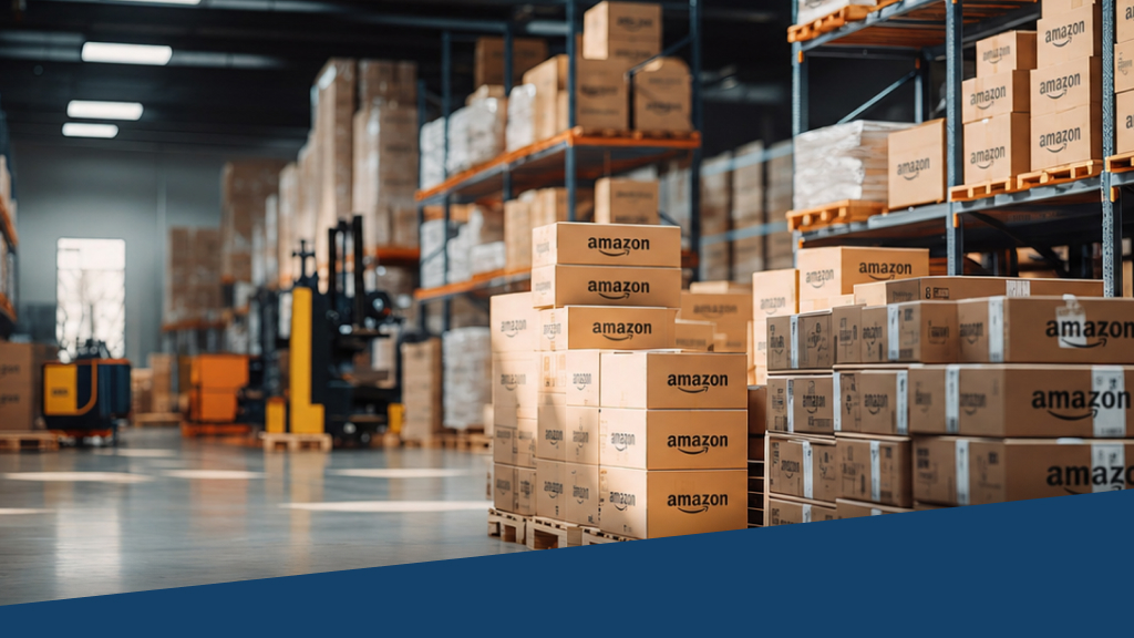 An image from inside a warehouse. To the right side, there are multiple boxes with 'Amazon' written on them.